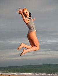 Very skinny and natty teen jumping and flying naked on the shore